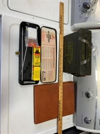 #123: Ammo can, gun cleaning kit, leather rifle holster and a yard stick
Ammo can, gun cleaning kit and a yard stick