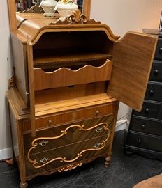 Inside view of the ornate chest, with curved front drawers