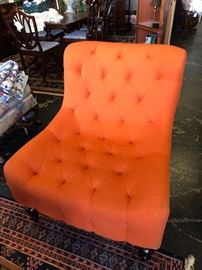 Tufted Orange Chair with wooden legs with rollers