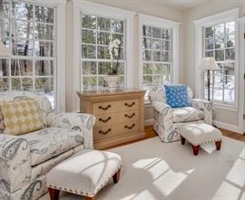 Overstuffed upholstered easy chairs with ottomans