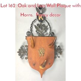 Lot 162 Oak and Iron Wall Plaque with Horns. Fancy decor