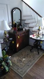 Karastan area rug, marble top table, antique cupboard, Victorian side table, dome tope wall mirror.