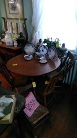 Round table with 4 chairs, child's rocker, flow blue china and more oil lamps in the back!