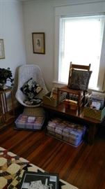 Sports cards and more sports cards, coffee table, plant stand, wicker chair.