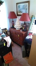 Antique chest of drawers, lantern lamps, while lighted ceramic Christmas tree, etc.