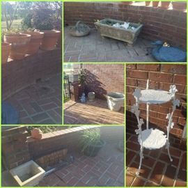 Various concrete planters, terra cotta pots, iron plant stand, window planters, and more.