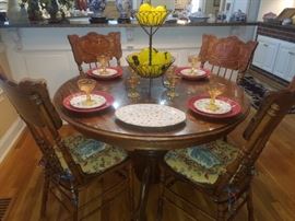 Oak, round table with pedestal base & 4 chairs; glass lemons in centerpiece, Godinger plates, & more.