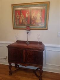 Antique mahogany server, framed print, table lamp, & crystal.