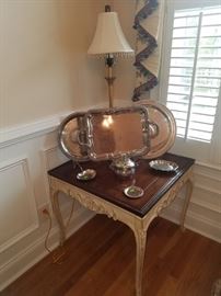 French Provential accent table, silver plate, and table lamp.