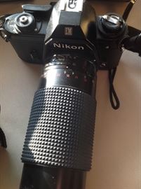 35mm Nikon camera with telephoto lens