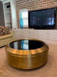 Gold wrapped coffee table with glass top measures 48" diameter and 18"H