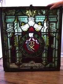 Glass window purchased from a dealer who said it came from a church in Charleston in the 1800s. The frame is hand forged iron. We staged a light behind the glass for this photo to showcase it's beauty.