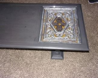 Gray wood coffee table with glass covered deco.