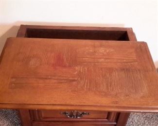 End table with two drawers and hidden compartment.