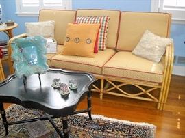 FICKS REED CO RATTAN SOFA AND BLACK COFFEE TABLE WITH GOLD ACCENT