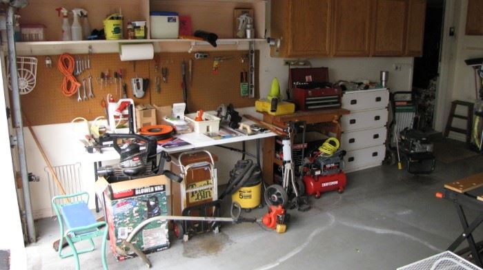 Garage full of clean outdoor tools and equipment . 