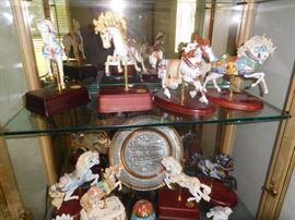 A collection of at least a dozen Lenox carousel horses