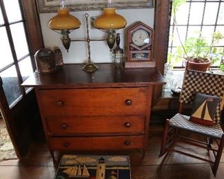 Double student lamp on early chest of drawers.
