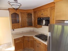 oak kitchen cabinets , stainless steel refrigerator , stainless steel cook top microwave granite counter tops dishwasher stainless steel kitchen sink