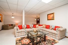 Original artwork, L-shaped sofa, glasstop table, rug, etc.