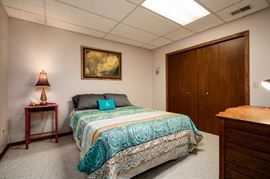 mattress and bed frame; linens; bedside table, art and lamp