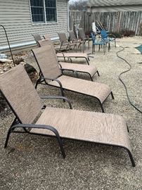 four reclining pool chairs.  five matching patio chairs. two blue chairs. three hoses.