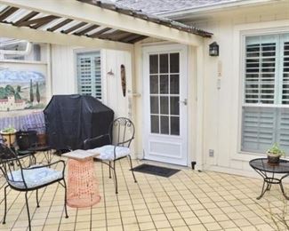 Wrought iron chairs and occasional tables.