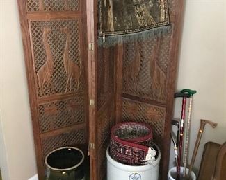 Large carved folding screen behind a couple old crocks and planters!