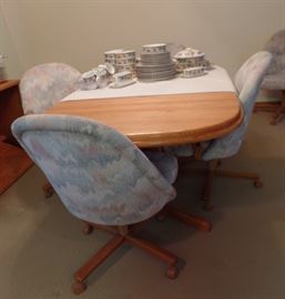 OAK TABLE WITH LEAVES AND 6 CHAIRS ON WHEELS - CAPTIAN CHAIRS HAVE OAK ARMS