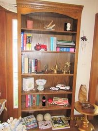 BOOKCASE FILLED WITH BOOKS AND TRINKETS 