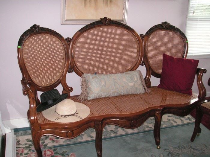 Cane & balloon back carved settee