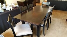 Skovby "Wenge" black dining room extendtable table and 6 chairs.  Measures 6' by 3' in this photo and extends to 8' long with a built-in leaf. Very cool! Video showing us extending this table can be found at https://youtu.be/td-tOgNUqzo.