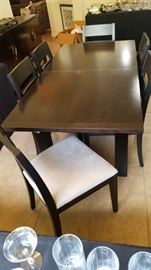 Skovby "Wenge" black dining room table and 6 chairs.  Measures 6' by 3' in this photo and extends to seat 12 with built-in leaves. Very cool! Video showing us extending this table can be found at https://youtu.be/td-tOgNUqzo.