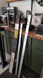 Tall item on left is a piece of the shaft frequency meter machine. The other 2 tall items are yard sticks made for golf clubs.