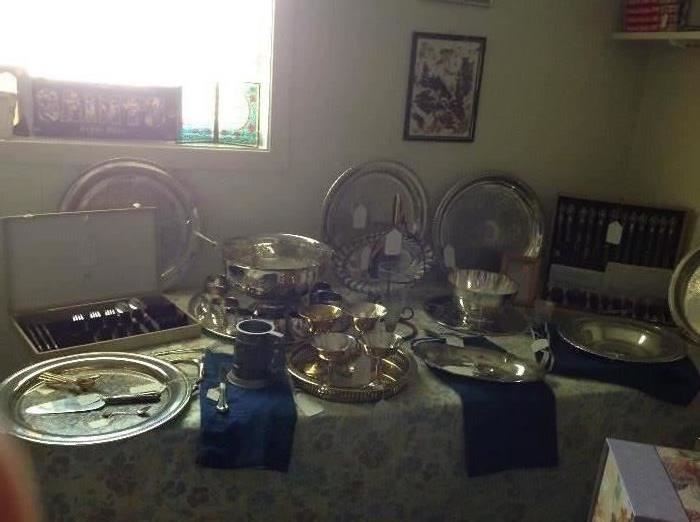 Several silver plate trays, two flatware sets in chest (one silver plate and one stainless steel), Leonard silver plate punch bowl with tens cups and ladle along with other serving pieces 