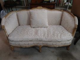 One of a pair of good Frenchy loveseats, with down cushions.