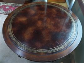 Greek key tooled leather border on the tops of the pair of mahogany drum tables.