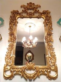 Beautifully detailed gilt wood wall mirror, with beveled glass.