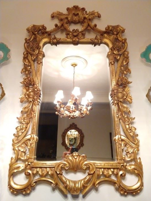 Beautifully detailed gilt wood wall mirror, with beveled glass.