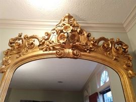 Detail at the top of the huge gilt wood mirror.