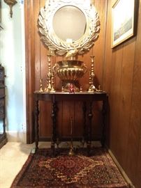 Antique gate-leg mahogany table, with brass candlestick collection, round, beveled wall mirror and small Persian Bijar ruglet.