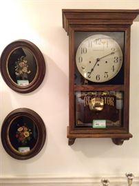 Pair of hand painted floral still life's on black glass, in antique oval frames.