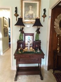 American Empire desk, with tilt mirror, vintage brass inkwell with elephant head feet, antique framed French hussy and pair of the nicest, most friendly blackamoor table lamps you've ever seen.