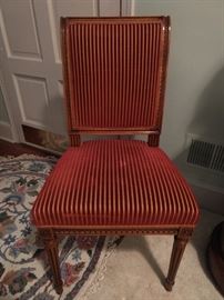 One of a pair of vintage French wooden side chairs, with striped velvet fabric.