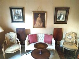 Part of the master bedroom suite. I guess visitors can wait their turn?!? Pair of French wooden armchairs, with hand embroidered seats and backs, French style settee, pair of antique tilt-top tables, assorted relations portraits in great wooden frames, 2-tiered side table, with leather top.