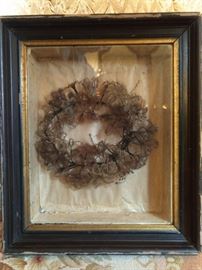 Umm. Guess what this is...Give up?!? OK, I'll tell you. It's a Victorian folly - a mourning wreath made of human hair - in a thoughtfully executed shadowbox frame, no less. A mourning wreath could be made up of one member’s hair or a composite of an entire family. As family members died, hair was saved in a “hair receiver.” When enough was accumulated, the hair was fashioned into flowers and leaves by twisting and sewing it around shaped wire forms.