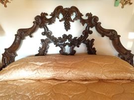 Ornately carved wooden headboard.