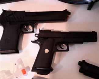 Six airsoft pistols, with targets and pellets.