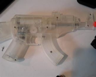 Six airsoft pistols, with targets and pellets.