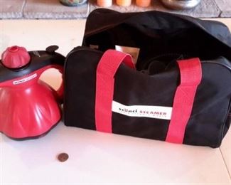 Scuncii portable steamer with accessories and carry case, like new.